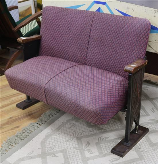 A 1920s cinema bench, with folding seat W.113cm